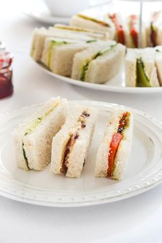 two plates with sandwiches on them sitting on a table