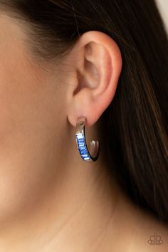 The front of a thick silver hoop is encrusted in glittery blue emerald cut rhinestones, creating a glamorous pop of color. Earring attaches to a standard post fitting. Hoop measures approximately 1" in diameter.

 Sold as one pair of hoop earrings. Textured Gold Ring, Trendy Fringe, Emerald Style, Blue Emerald, Oil Spill, Jewelry Images, Paparazzi Accessories, Blue Gems, White Rhinestone