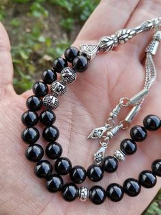 ✔️ This is a 33 pcs magnificent personalized rosary made of AAA quality 8 mm black onyx beads. ✔️ It is a customized elegant and striking tasbih gift for Men. ✔️ Each order comes in a special box. ✔️ PLEASE CLICK THE LINK FOR ALL PRAYER BEADS MODELS https://www.etsy.com/shop/GoodJewelsofYazmasal Note: As a natural feature the stones beads may have some variations. SHIPPING: United States (Standart/DHL eCommerce/usps): 7-10 business days United States (Express/FedEx): 3-5 business days Canada (Ex Black 8mm Beads For Gifts, Traditional Black Beads For Gift, Adjustable Black Rosary With 8mm Beads, Onyx Black Beads For Gifts, Adjustable Black Beaded Necklaces With 8mm Beads, Traditional Black Gemstone Beads, Handmade Black Spiritual Beads, Handmade Spiritual Black Beads, Spiritual Black Beads For Jewelry Making