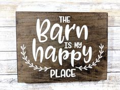 a wooden sign that says the barn is my happy place