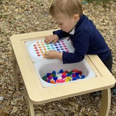 a toddler playing with an activity tray