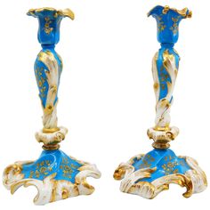 two blue and gold vases sitting side by side on top of each other in front of a white background