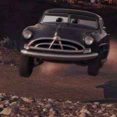 a car flying through the air over rocks