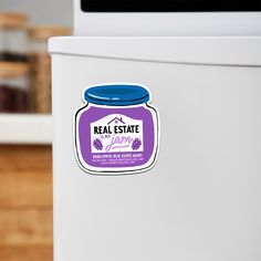 a sticker on the side of a refrigerator saying, real estate with grape jam