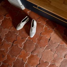 two pairs of shoes sitting on the floor