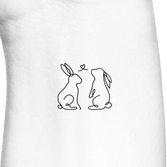 a drawing of two rabbits sitting next to each other on a white t - shirt