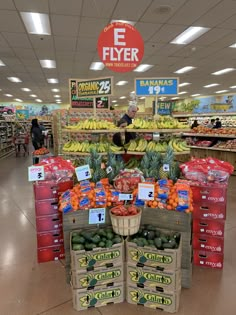 the produce section of a grocery store filled with fruits and vegetables