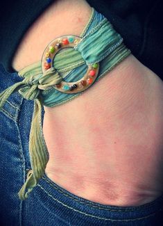 a close up of a person's stomach wearing a bracelet with beads on it