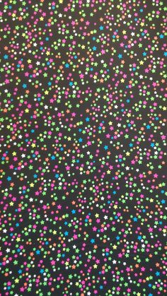 multicolored stars are scattered on a black background