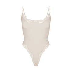 Buttery-soft and ultra-flattering, this romantic stretchy lace trim bodysuit is a must-have. Features a scoop front neckline, adjustable straps, and a 100% cotton gusset with snap closure. Fits true to size. Cream Bodysuit, Doll Halloween Costume, Cami Bodysuit, Bling Acrylic Nails, Basic Fits, Romantic Lace, Going Out Tops, Lace Cami, Elevate Your Look