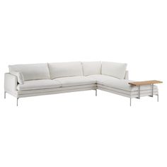 a white couch with a wooden table on top of it's backrests