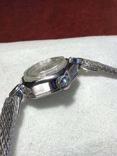 Excellent working and very good cosmetic condition. Comes with a white gold filled top and stainless steel bottom band. Fits a 5 3/4 inch wrist. Case size measures 16mm. 90 day money back guarantee, no questions asked, and 2-year warranty on our service. Silver Diamond Watch With Metal Dial For Anniversary, Anniversary Silver Diamond Watch With Metal Dial, Metal Jewelry And Watches With Diamond Hour Markers, Classic Silver Diamond Watch, Vintage Silver Stainless Steel Watches, Formal Round Analog Diamond Watch, White Gold Analog Diamond Watch, Vintage White Gold Round Watch, Vintage White Gold Round Jewelry And Watches