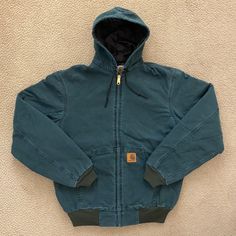 Nwot Carhartt J06 Quilted Nylon-Lined Sandstone Duck Active Jacket - "Hunter Green" (Htg) - Size Medium Tall New Without Tags! Never Worn. Discontinued, Made In The Usa In 1998. Product Features 12-Ounce, 100% Sandstone Cotton Duck Micro-Sanded, Then Garment-Washed For A Soft Hand Feel 100% Nylon Quilted To Polyester Midweight Lining Attached Quilt-Lined Hood With Adjustable Drawcord Zipper Front Two Front Hand-Warmer Pockets Rib-Knit Cuffs And Waistband Made In The Usa Approximate Measurements Denim Blanket, Carhartt Vest, Carhartt Detroit Jacket, Carhartt Hoodie, Carhartt Jackets, Carhartt Jacket