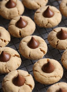 chocolate chip cookies cooling on a rack with other cookies in the backgroung