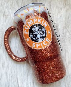 a starbucks cup with the words pumpkin spice written on it and glittered in gold