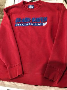 Blue 84 Grand Haven, Michigan Red Sweatshirt Size Medium Measures 26.5" from shoulder to hem Measures 21.5" from armpit to armpit laying flat Pre-owned but in good condition Grand Haven Michigan, Grand Haven, Red Sweatshirt, Michigan, Size Medium, Sweatshirts, Red, Blue