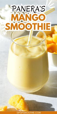 mango smoothie in a glass with a straw sticking out of it