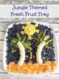 a plate with fruits and vegetables made to look like the face of a tree on it