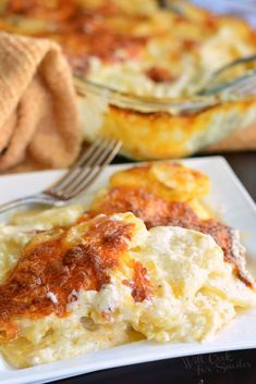 a white plate topped with lasagna casserole next to a fork