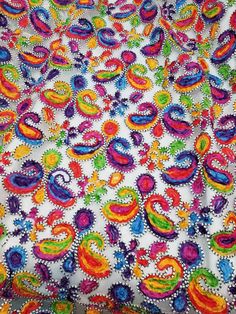 an image of a colorful cloth with beads on it