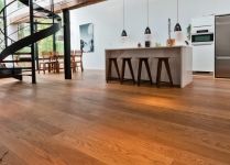 an open floor plan with stairs leading up to the kitchen