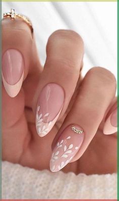 a woman's hand with some pink and white nail polishes on her nails