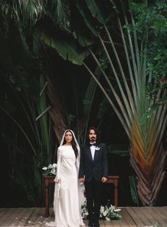 a bride and groom standing on a wooden platform