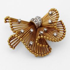 "Retro brooch in form of a folded ribbon, made of 18 K (.750) yellow and white gold, accented with Diamonds - 0.5 approx. total carat weight, G / VS. This splendid brooch is 1 3/4\" long, 1 3/8\" wide and weighs 17.8 grams. EA988" Yellow Gold Diamond Brooches For Formal Occasions, Formal Yellow Gold Diamond Brooches, Formal Yellow Gold Diamond Brooch, Gold Brooches With Diamond Accents For Formal Occasions, Diamond Yellow Gold Brooch For Anniversary, Anniversary Diamond Brooch In Yellow Gold, Elegant Yellow Gold Diamond Brooches, Anniversary Yellow Gold Diamond Brooch, Elegant Gold Brooches With Diamond Accents