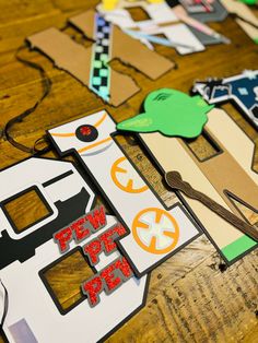 some cut outs and scissors on a wooden table