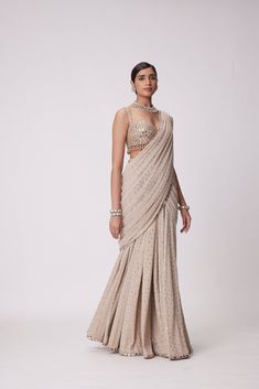 Light Beige Georgette pre Draped Saree with Real Hand Cut Mirror Embroidered Sleeveless Blouse.From Vvani Vats Jugmug's collection.DELIVERY TIMEPlease allow 8-12 weeks for your outfit to arrive.FABRIC DETAILSSaree - GeorgetteBlouse - GeorgetteProfessional cleaning only. Pre Draped Saree, Mirror Blouse, Drape Sarees, Sari Design, Mirror Embroidery, Weddings Receptions, Drape Saree, Indian Wedding Wear