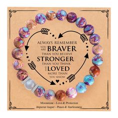 a heart shaped bracelet with beads and an inspirational quote on the front saying, you're braver than you believe