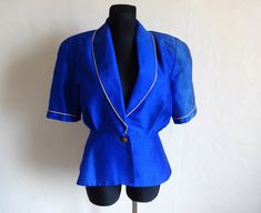 "Label: SHEILA DE VRIES Material: Silk  Color: Dark blue & Golden  Marked size: 40 ( check measurements, please )   Measurements (lying flat)- - double for circumference  Length- 64 cm ( 25.2 \" )  Pit to pit- 52 cm ( 20.5 \" )  Sleeve- 32.5 cm ( 12.8 \" )  Shoulder to shoulder- 41.5 cm ( 16.3 \" )   Vintage condition: Good,  but here is missing inside push button  (please use zoom button to see more)   All things in our shop are used  Please check measurements to insure a proper fit. Remember to allow yourself some extra room for movement. You can compare these with something from your closet that fits you well. Ready to ship  Thank You for visit  @" Luxury Vintage Blue Blazer, Silk Blazer, Womens Blazers, Vintage Designer, Push Button, Blazer Suit, Vintage Designs, Dark Blue, Trim