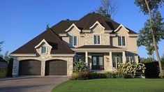 a large house with two car garages in front of it