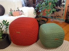 three crocheted poufles are sitting on the floor