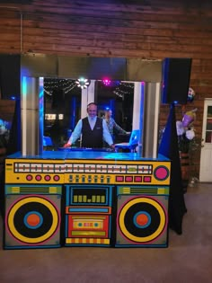 a man standing in front of a boomboard on top of a dance floor at a party