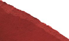 a close up of a red substance on a white background