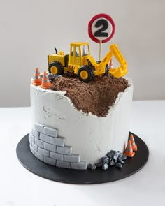 there is a cake with construction vehicles on it