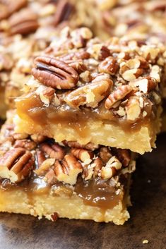 three pieces of pecan bars stacked on top of each other