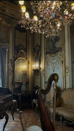 an ornately decorated room with a harp and chandelier in the center,