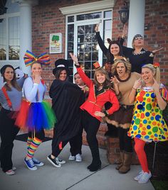 a group of people dressed up in costumes posing for a photo on the front porch