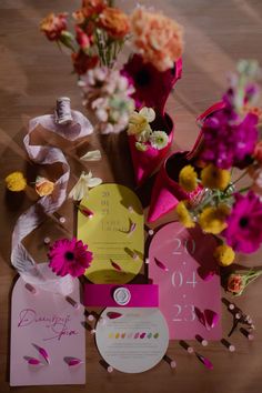 the table is covered with flowers and cards