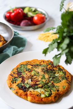 an omelet is sitting on a plate next to other plates with fruit and vegetables