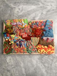 a wooden tray filled with candy and candies