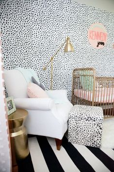 a baby's room with black and white wallpaper, gold accents and a leopard print crib