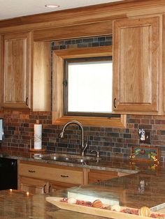 a kitchen with wooden cabinets and granite counter tops