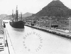 an old photo of a large ship in the water next to a dock with people on it