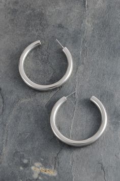 Add a touch of shine with our round hoop earrings! Available in silver or gold with a high polish finish, these 1.75" hoops are lightweight for all-day comfort. Perfectly pairs with any outfit - from puff hem dresses to shorts or maxis. Lead and nickel compliant with double E-coating to prevent tarnishing. Modern Everyday Jewelry For Spring, Nickel-free Hoop Earrings For Spring, Elegant Round Hoop Earrings For Spring, Spring Hoop Earrings For Everyday, Silver Metal Hoop Earrings For Spring, Spring Silver Metal Hoop Earrings, Chic Small Hoop Earrings For Spring, Modern Silver Jewelry For Spring, Nickel Free Hoop Earrings For Spring