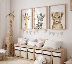 a baby's room with three pictures on the wall and two giraffes