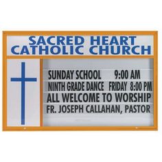 a church sign with the words sacred heart catholic school written in blue and orange on it