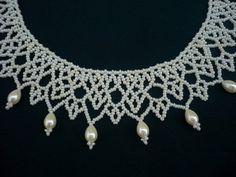 a white necklace with pearls on it